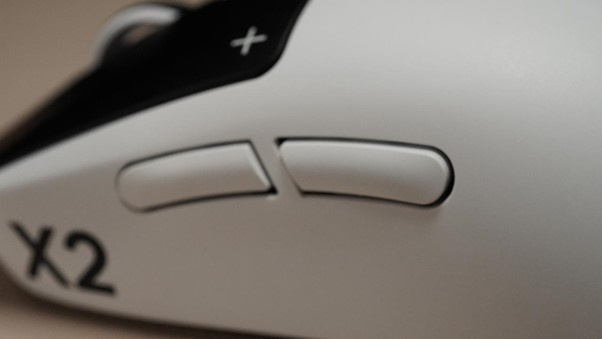 Two programmable side buttons sit high on the shell, positioned to minimise accidental presses during intense play.