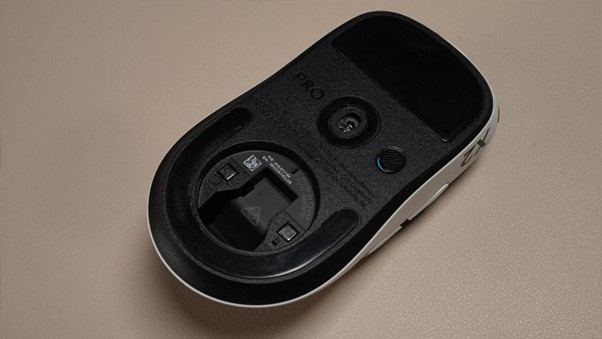 The underside reveals the Hero 2 sensor, large PTFE feet, and the magnetic dongle storage compartment that keeps the Lightspeed receiver secure between sessions.