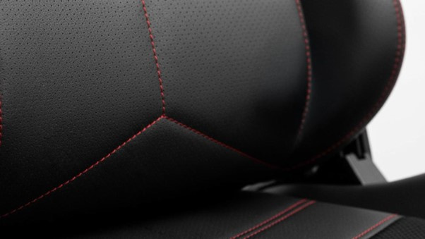 Close-up of a gaming chair’s lower back padding, showing the contoured lumbar support designed to maintain natural spine alignment
