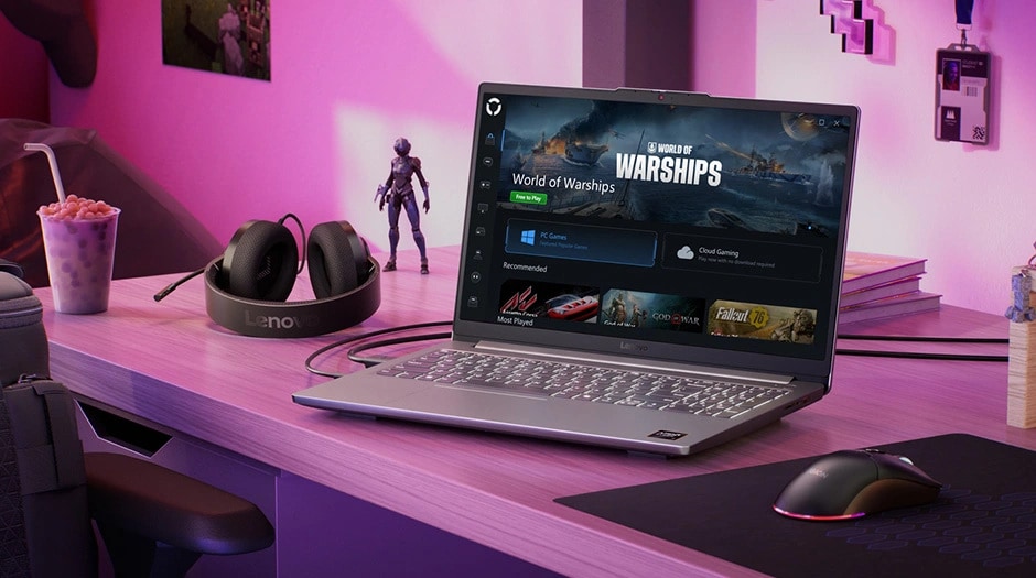 The Lenovo LOQ Essential 15ARP10 gaming laptop on a desk between a headset and mouse, with a World of Warships interface on the display.